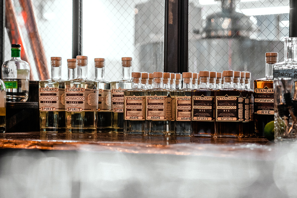Rows of spirit bottles in a distillery.