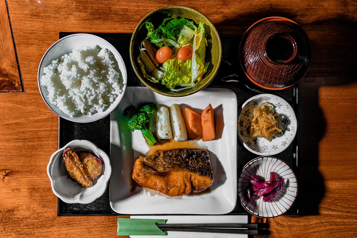 A tray filled with a variety of dishes and food.
