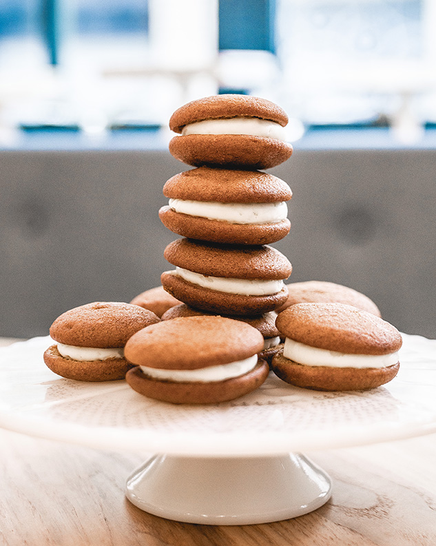 A stack of cookies surrounded by other cookies.