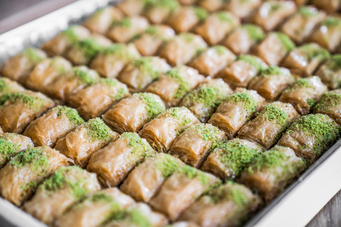 Rows of pastries dusted with a green powder.