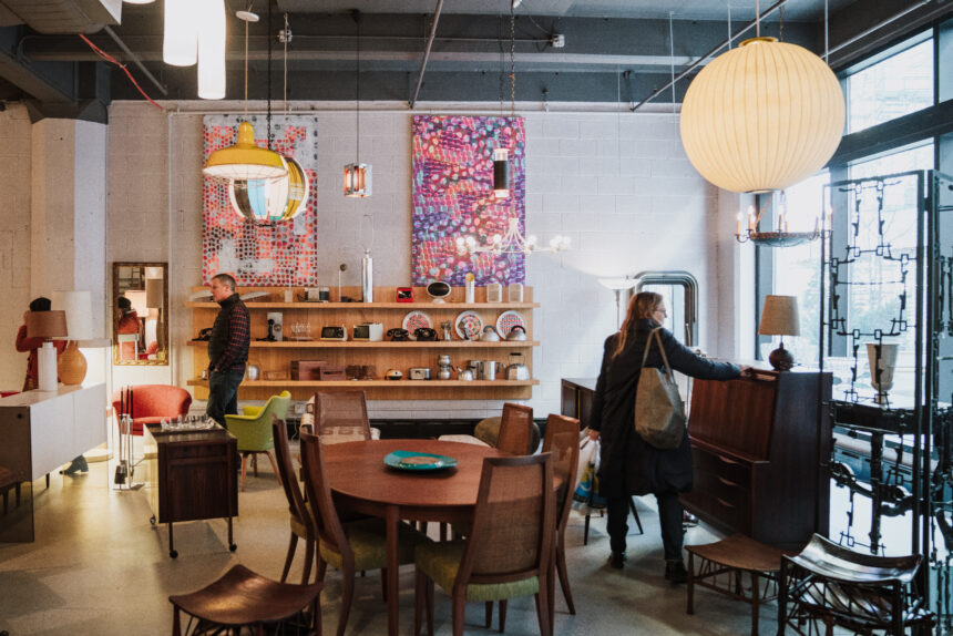 People are walking through a furniture store.