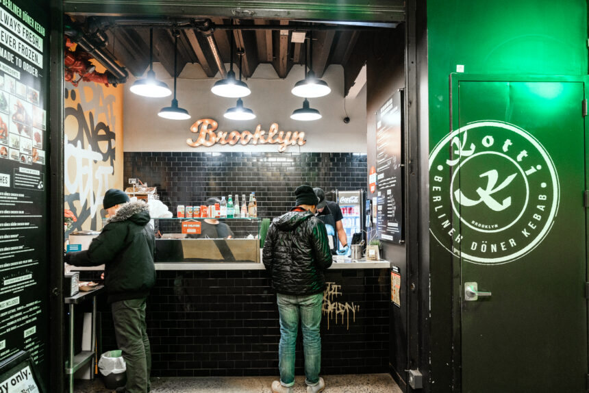 People are ordering at a counter in a restaurant.