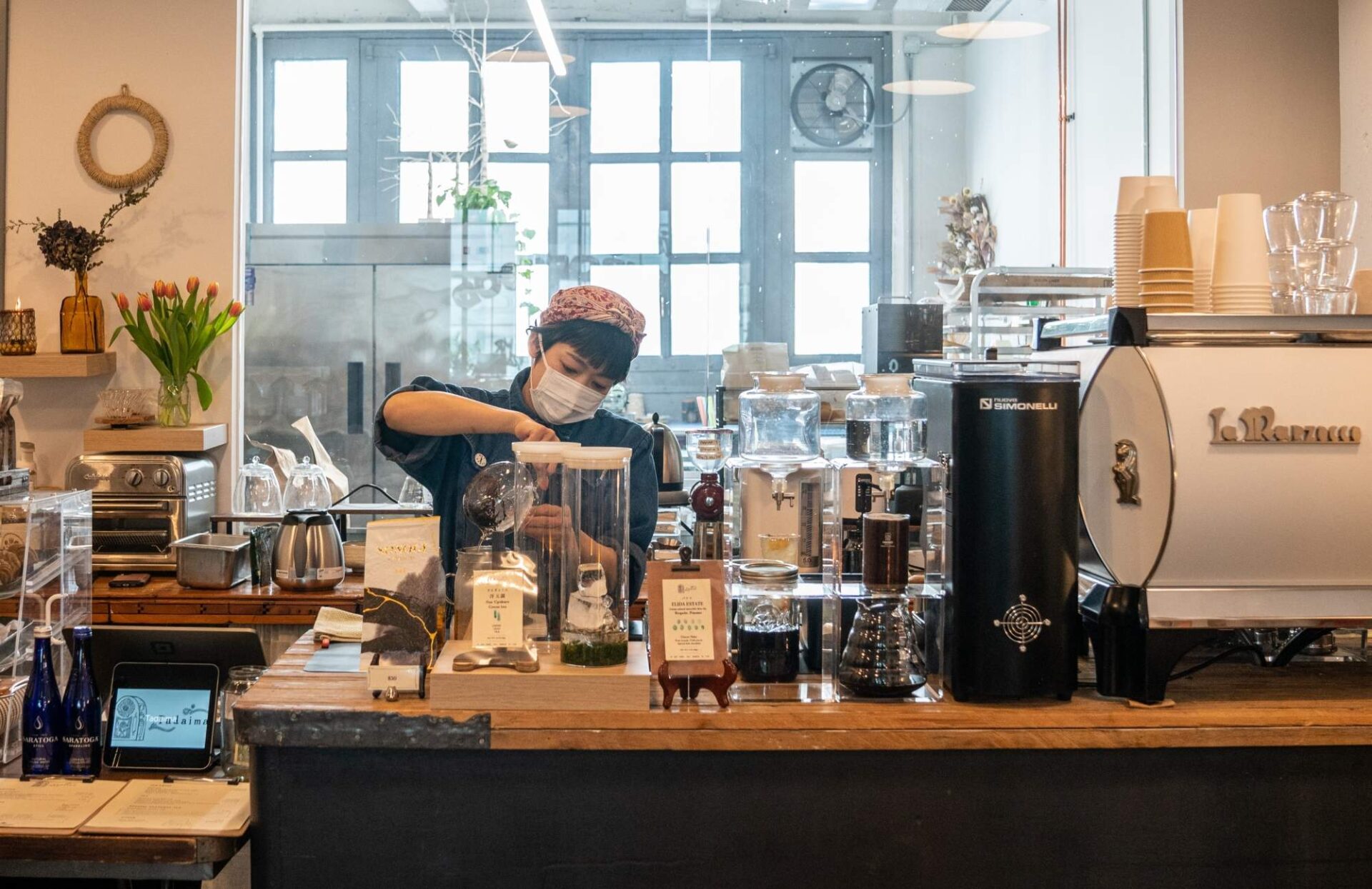 A barista is making a coffee drink.