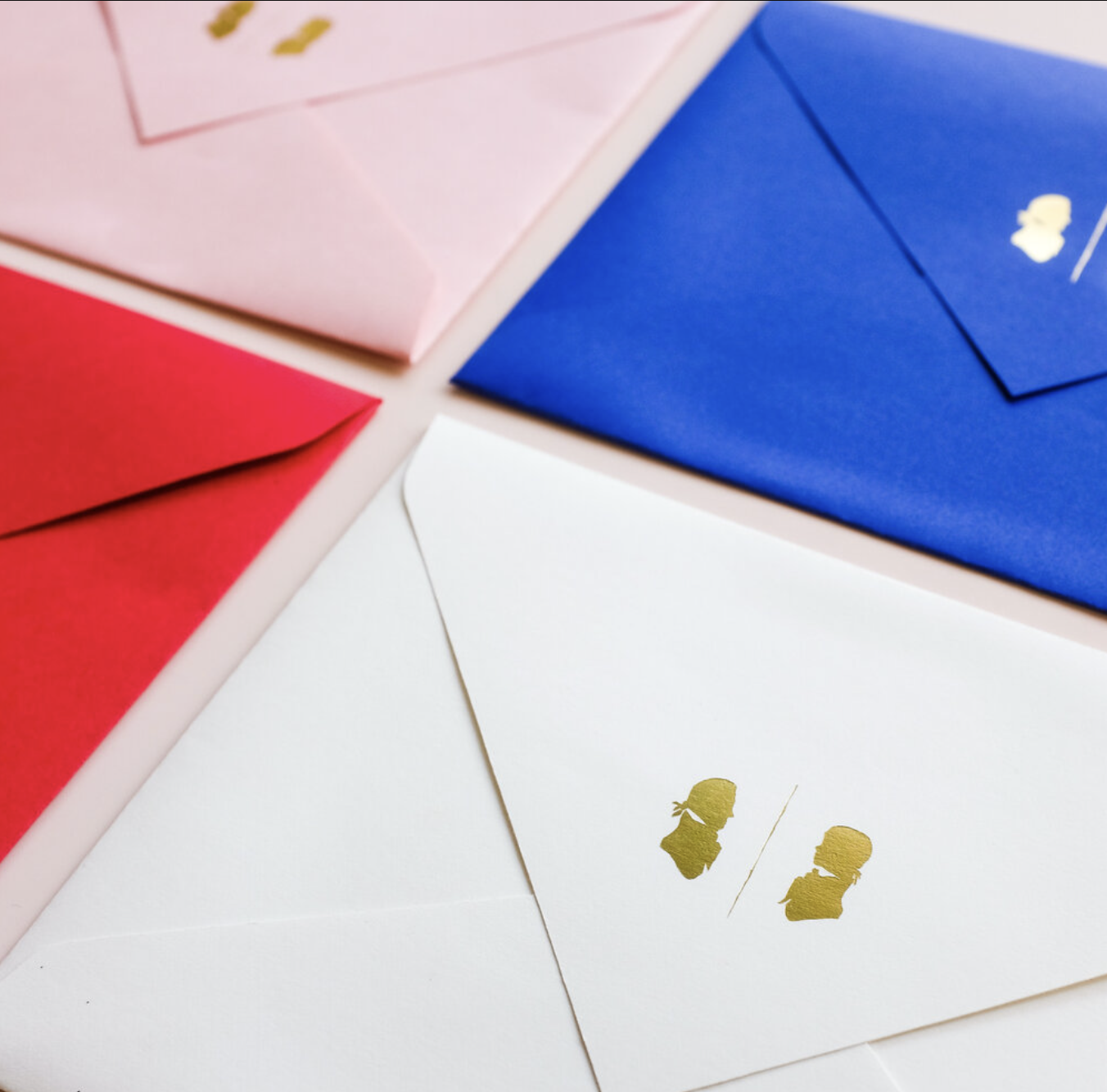 There are colored envelopes on a table.
