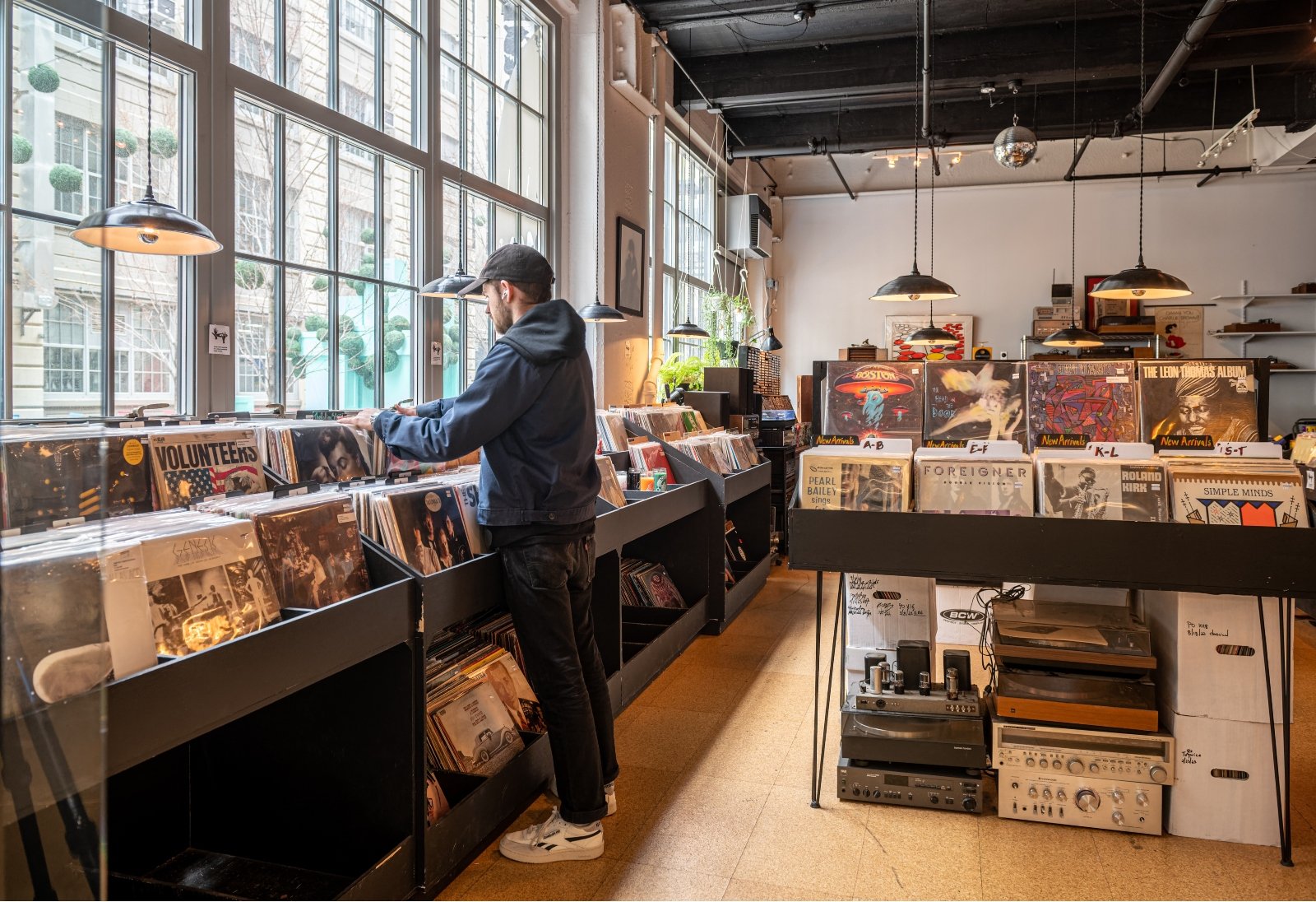 Someone is looking through records in a record shop.