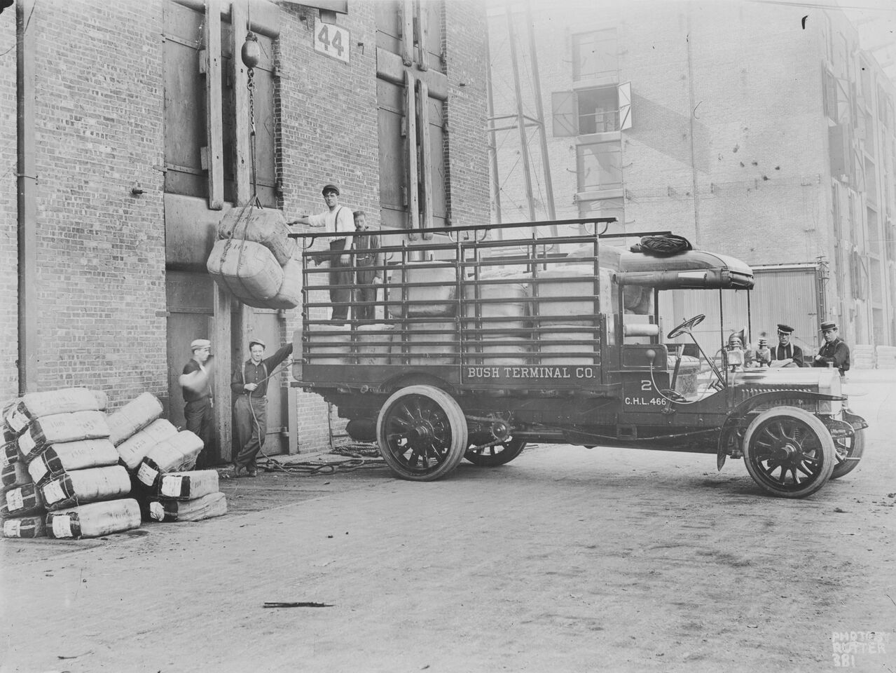 A historic image of people working on a truck.
