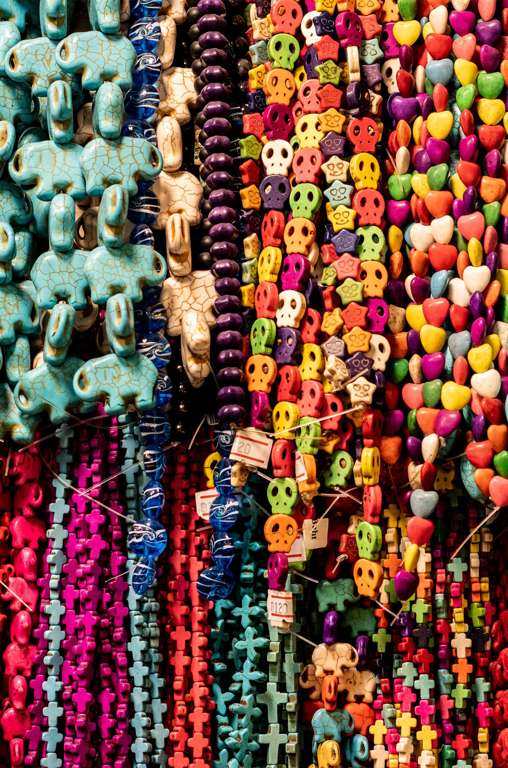 A wall of beads hanging in a jewelry-making store.